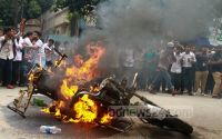 Student protesters set traffic police sergeant’s motorbike on fire